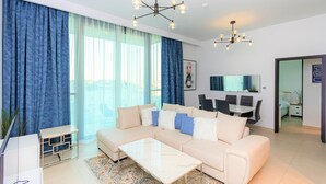 Comfort Apartment (1 Bedroom) | Living room | 1-cm plasma TV with satellite channels, TV - Amazing Stay in Downtown Views (Dubai)