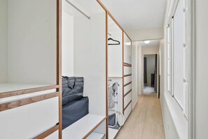 A narrow hallway with a wooden-framed closet, a grey sofa, and a vacuum cleaner. - Ocean Front! 8BR Villa with Pool near Malmok Beach (Malmok)