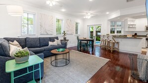 A spacious living room with a sofa, coffee table, and dining area. - A KEY ESCAPE ~ 3 Bedroom, 2.5 Bathroom Home in Old Town /Private Heated Pool! (Key West)