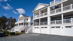 A multi-story residential building with a central staircase, multiple balconies, and a garage. - WALK TO BEACH -  5 BR, DOG-FRIENDLY BEAUTY - 101 SWEDES ST, DEWEY BEACH (Dewey Beach)