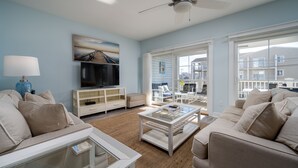 A living room with a TV, sofa, coffee table, and a ceiling fan. - WALK TO BEACH -  5 BR, DOG-FRIENDLY BEAUTY - 101 SWEDES ST, DEWEY BEACH (Dewey Beach)
