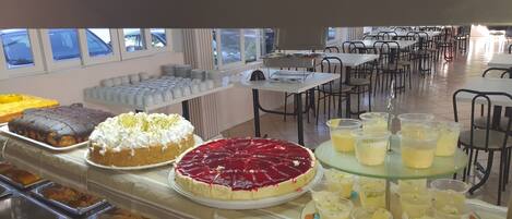 A buffet area with various desserts and beverages.