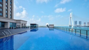 A rooftop pool with a clear view of a bridge and buildings in the background. - The Westin Haikou (Haikou)