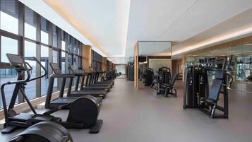 A gym with treadmills, elliptical machines, and weight equipment.