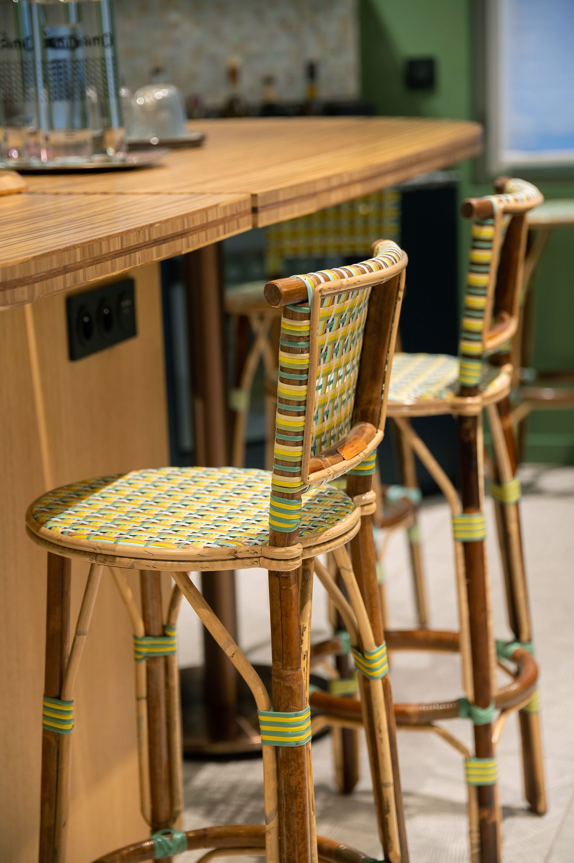 A bar area with wooden chairs and a bar counter.