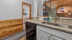 A modern kitchen with granite countertops, a dishwasher, and a built-in stove. - Creekside Unit 403 Spacious 3 bedroom river views, private deck, picnic area (Winter Park)