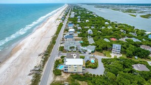 An aerial view of a coastal residential area with houses, a beach, and a road. - Eagles' Landing | Private Pool + Hot Tub, Views! (Surf City)