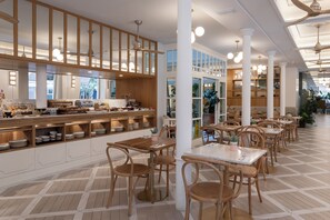 A modern restaurant interior with wooden tables and chairs, a buffet area, and large windows allowing natural light. - Malabar by Petit Palace Anteriormente Icon Malabar (Málaga)