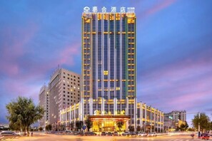 A high-rise hotel with a prominent entrance, multiple floors, and a modern architectural design. - Taihe Hotel (Guyuan)