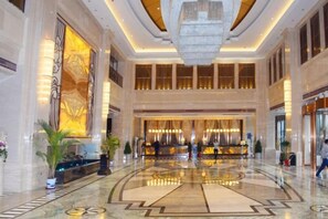 A spacious lobby with a grand chandelier, marble flooring, and a reception desk. - Binhu Hotel (Hanchuan)