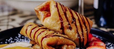 A plate of food with pancakes and fruit.