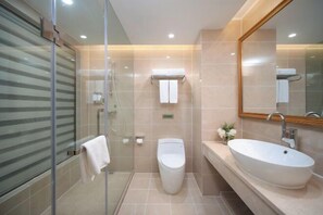 A modern bathroom with a glass shower enclosure, a toilet, and a large freestanding sink. - Vienna Hotel (Kunming Baiyun Road Metro Station Jiang'an) (Kunming)