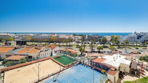 A coastal hotel with a tennis court, pool, and beach access.