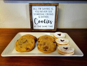 A plate of cookies with a sign above stating "All I'm saying is, you never see someone crying & eating Cookies at the same time."