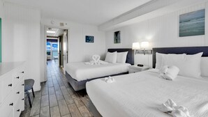 A hotel room with two beds, a desk, and a chair. There is a view of the ocean through the window. - Boardwalk Resort Condo Ocean-front Balcony 🏊 Pool 🏊 (Myrtle Beach)