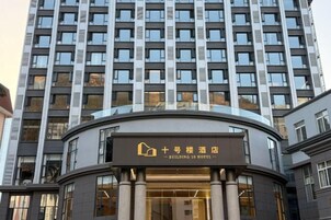 A modern hotel building with a prominent entrance and a sign indicating it is a 10-star hotel.