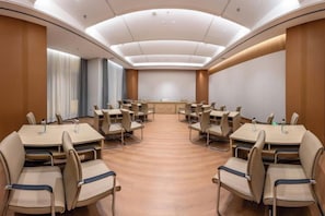 A conference room with a long table and chairs, a podium, and a large window with curtains. - Shihaolou Hotel (Gejiu)