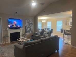 Smart TV, fireplace, books, computer monitors