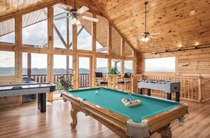 A wooden interior with a pool table, foosball table, and large windows offering mountain views. - Fuzzy's Dollywood View⛰, Location, 4 KING beds (Sevierville)