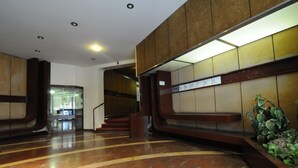 A lobby with a polished marble floor, wooden paneling, a staircase, and a reception desk. - Apartment in Trastevere free wi-fi 1GB/s fiber, AC, equipped kitchen, balcony. (Roma)