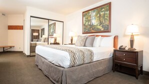 A hotel room with a large bed, a nightstand with a lamp, a mirror, and a painting on the wall. - Cliff Lodge Snowbird  Ski In/Ski Out 2 BR, 3 bath, sleeps 10, 12/31 - 1/7  (Sandy)