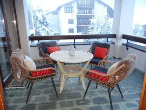 Relax on the balcony with a round table and four comfortable chairs.