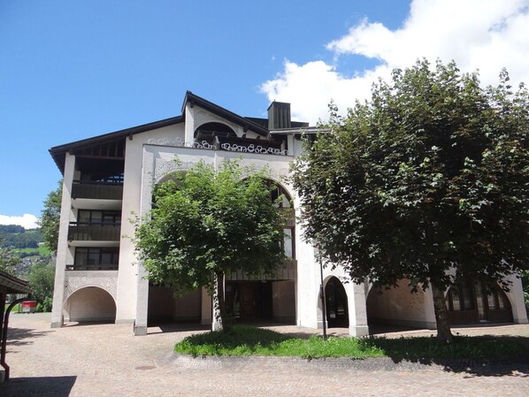 Stunning entrance with ornate archway, surrounded by a serene garden with mature trees.