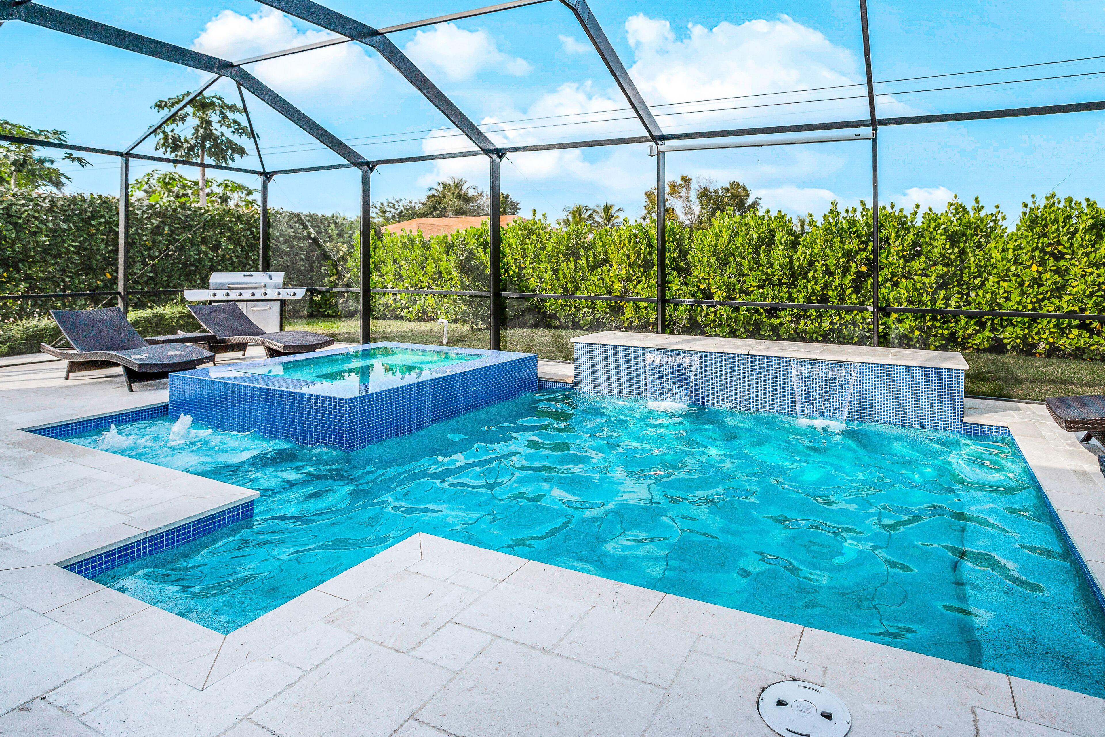 Dog-friendly home with outdoor kitchen, game room, cabana, pool spa & pool