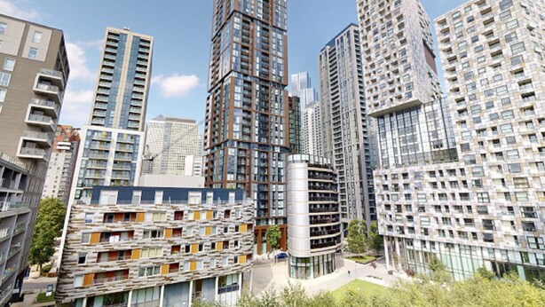 A modern high-rise residential building with multiple floors, balconies, and a central cylindrical structure. - Lovely apartment for 2 guests with WIFI, TV and balcony (London)