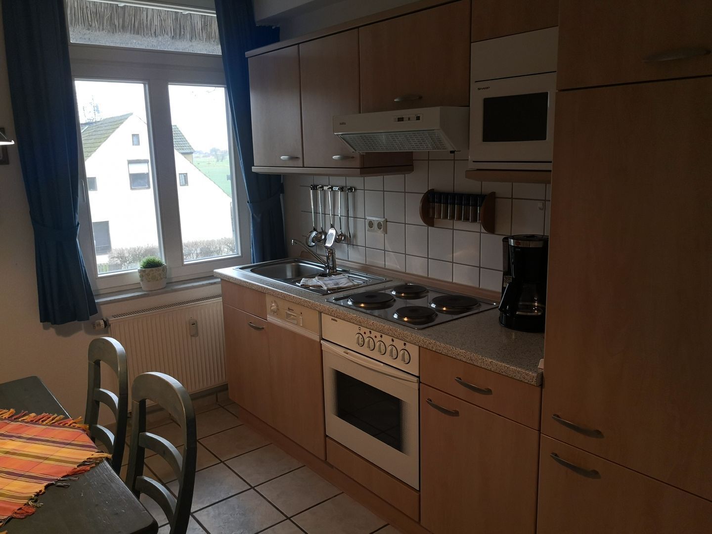Fridge, stovetop, dishwasher, coffee/tea maker