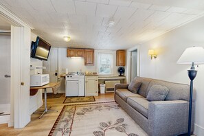 TV, books - Cute Riverfront Cabin in Great Location w/ Shared Pool, Kitchenette, & Free WiFi (Lincoln)