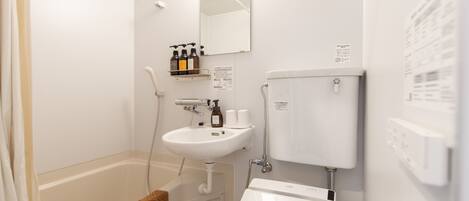A modern bathroom with a bathtub, a sink, and a toilet.