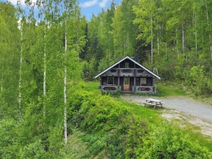 A log cabin with a porch, surrounded by dense forest. - Heinäsorsa by Interhome (Joutsa)