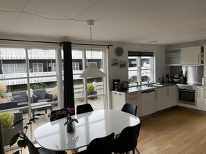 Enjoy meals in the kitchen with stainless steel appliances and a dining area with a table and chairs.