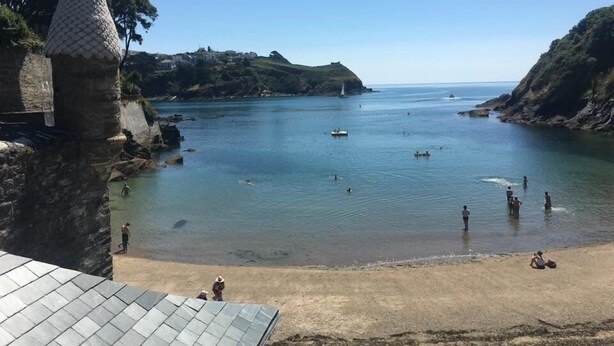 A coastal scene with a stone tower, calm sea, and a sandy beach. - The Slipway Fowey Harbour, Parking 1 Min & Garden (Fowey)