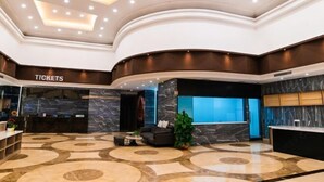 A lobby with a reception desk, seating area, and a 'Tickets' sign. - Movie Hotel (Guangzhou Pazhou Exhibition Center Store) (Guangzhou)