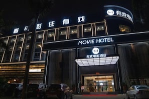 A building with a sign that reads 'MOVIE HOTEL' and another sign with Chinese characters. - Movie Hotel (Guangzhou Pazhou Exhibition Center Store) (Guangzhou)