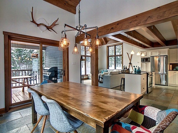 A spacious kitchen with wooden beams, a large island, and modern appliances.