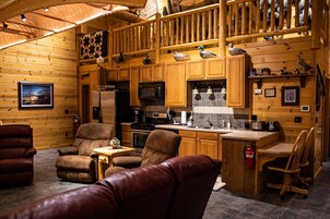 Cabin | Private kitchen | Microwave, cleaning supplies, paper towels, dining tables