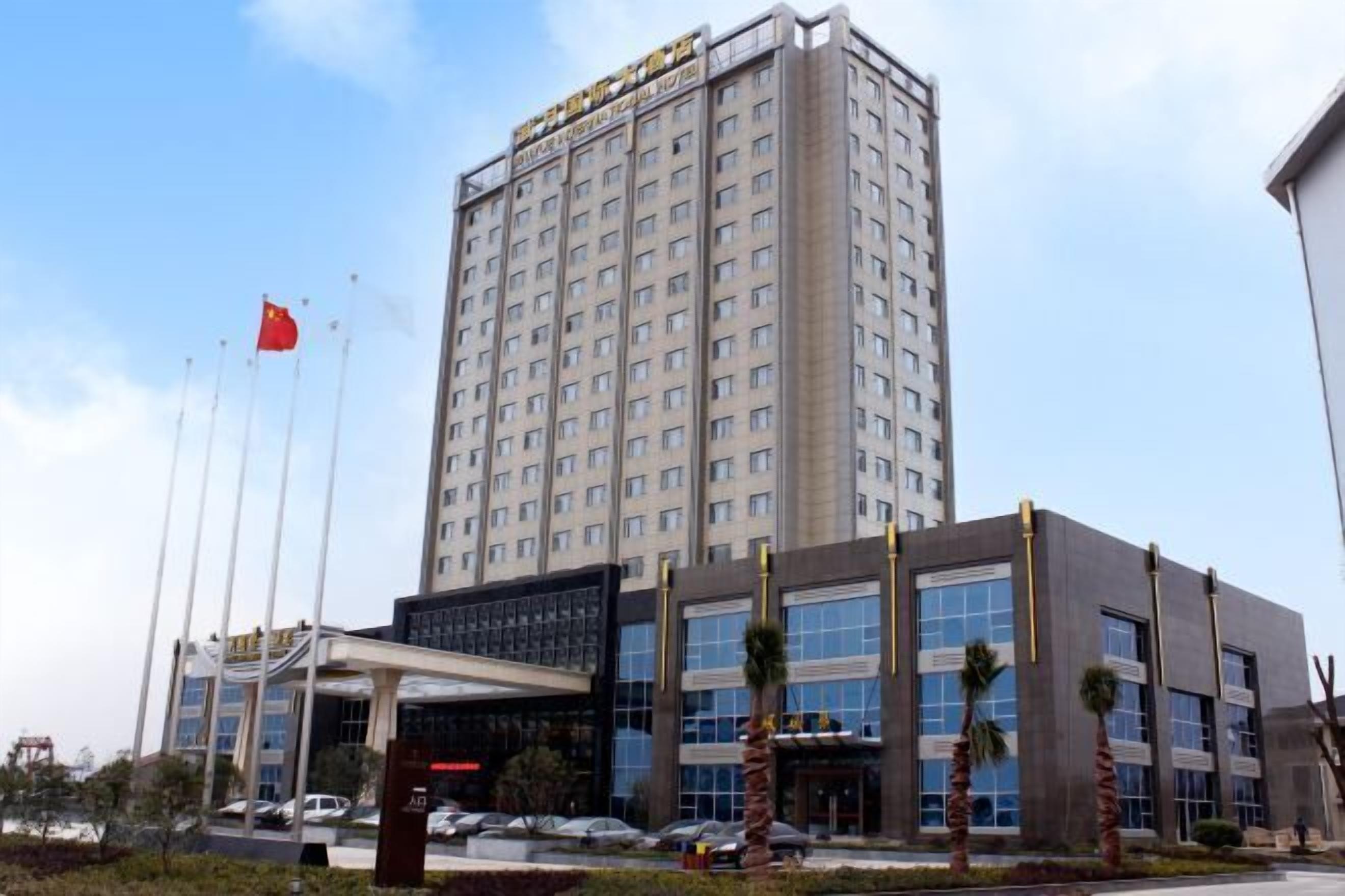 A multi-story hotel with a modern facade, large windows, and a prominent entrance area.