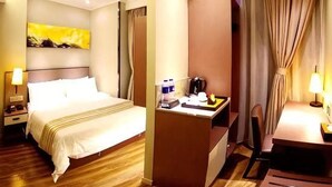 A hotel room with a bed, desk, chair, and curtains. - Home Inn Plus (Changping)