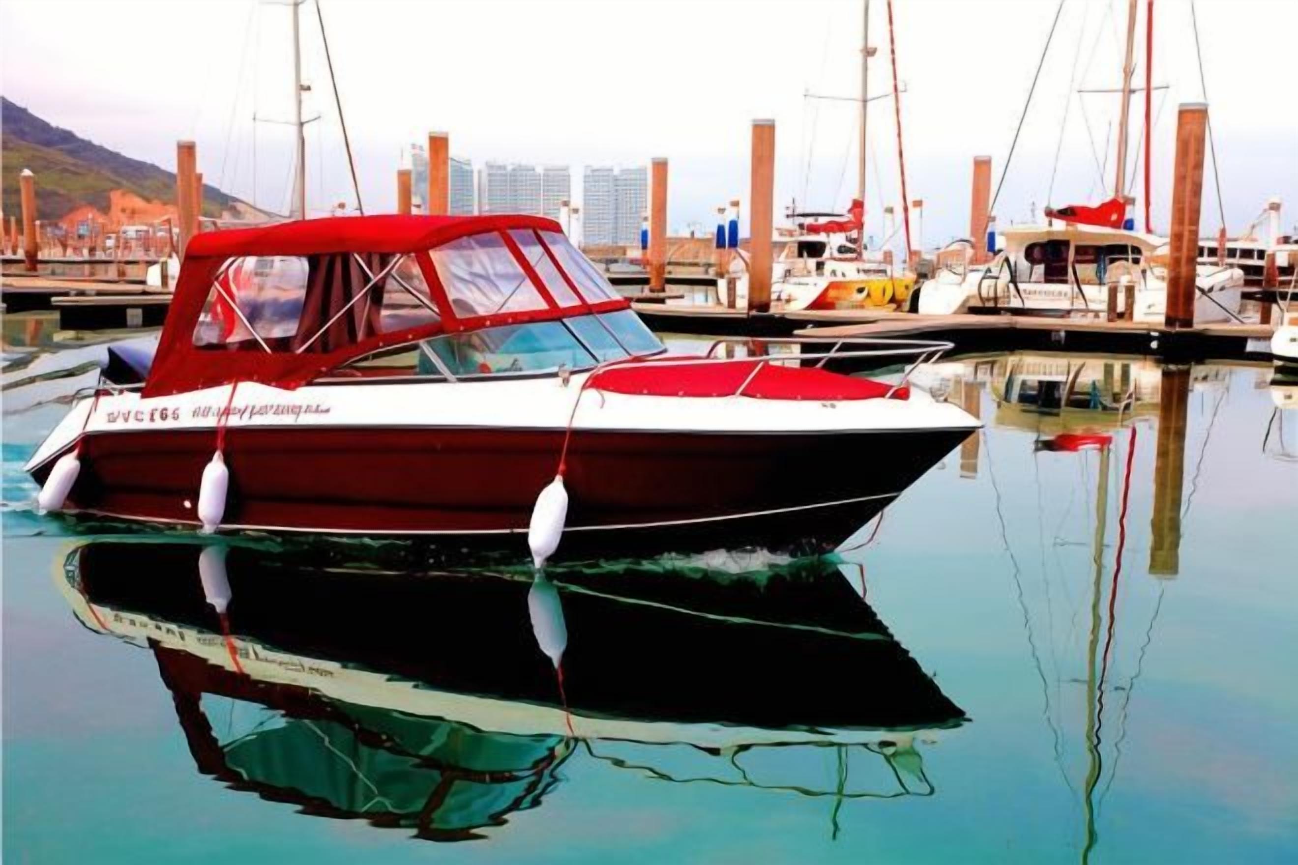 A boat docked at a marina with other boats and a cityscape in the background.