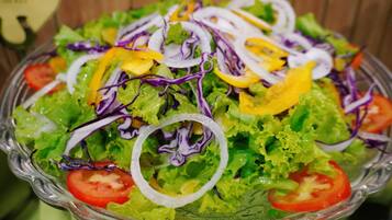 A glass bowl filled with a salad.