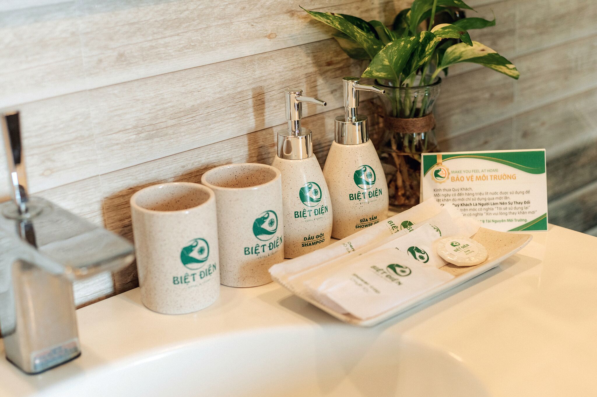 A bathroom counter with toiletries including a shampoo bottle, a conditioner bottle, and a facial cleanser.