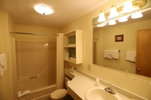 Enjoy a refreshing walk-in shower and modern amenities in this hotel bathroom.