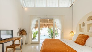 A bedroom with a bed, a desk, a TV, and a view of the outdoors. - Villa Casa Bocami Canggu By Azure Near Finns (Canggu)