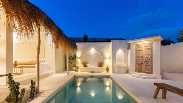 A pool area with a thatched roof, seating, and a decorative door. - Villa Casa Bocami Canggu By Azure Near Finns (Canggu)