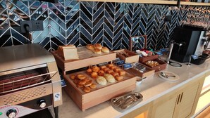 A buffet setup with various baked goods and a coffee machine. - Fairfield by Marriott Shenzhen Shenshan Special Cooperation Zone (Shanwei)