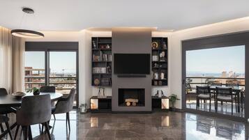 Deluxe Apartment, 2 Bedrooms, Sea View | Living room | 50-inch Smart TV with digital channels, TV, Netflix