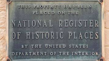 A plaque on a wall stating the property is on the National Register of Historic Places.